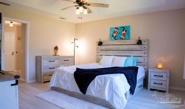 a bedroom with a bed and a chandelier