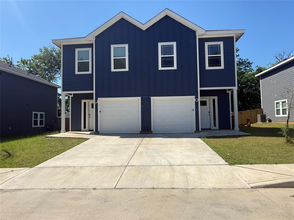 412 East 7th Street, Unit 2 Bonham, TX 75418 - Photo 1 of 20 a front view of a house with a yard and garage