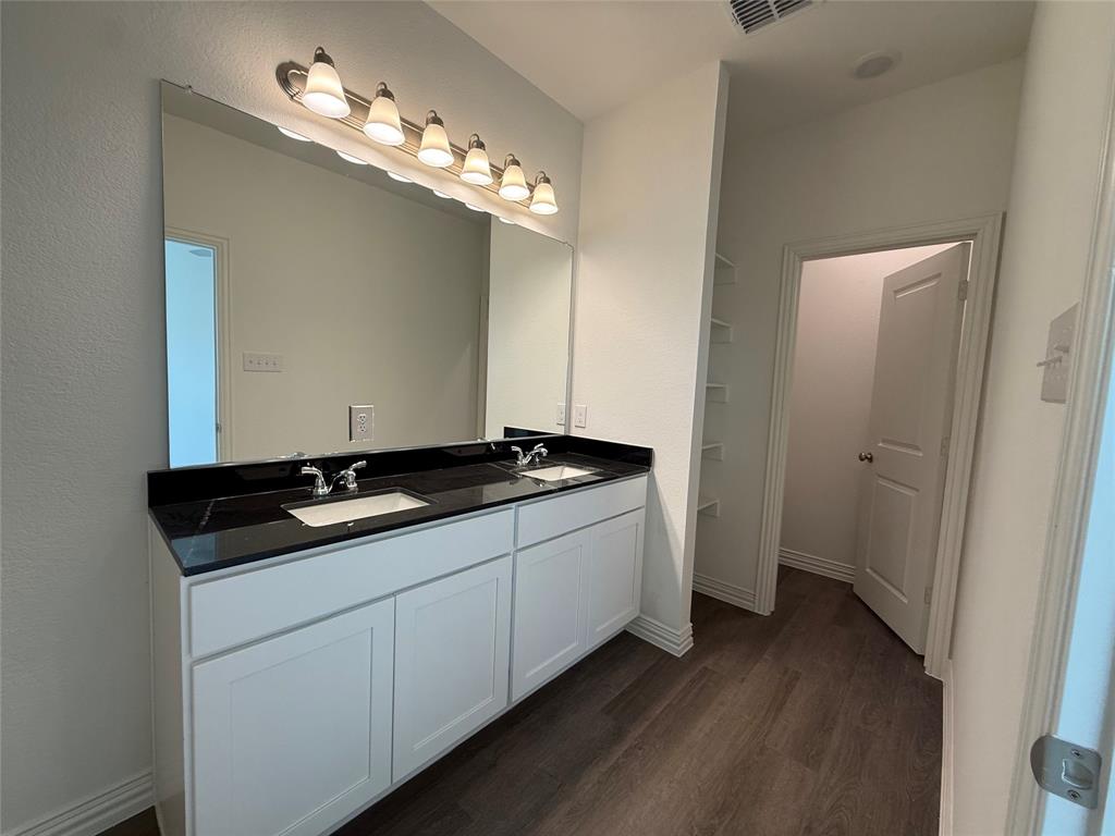 412 East 7th Street, Unit 2 Bonham, TX 75418 - Photo 11 of 20 a bathroom with a sink and a mirror