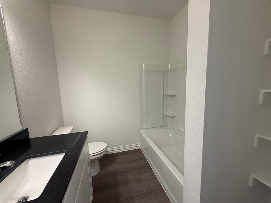 412 East 7th Street, Unit 2 Bonham, TX 75418 - Photo 14 of 20 a bathroom with a sink and a toilet