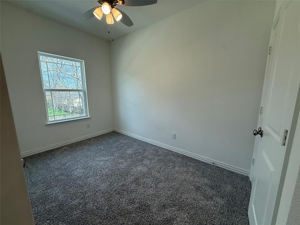 412 East 7th Street, Unit 2 Bonham, TX 75418 - Photo 16 of 20 an empty room with windows and fan