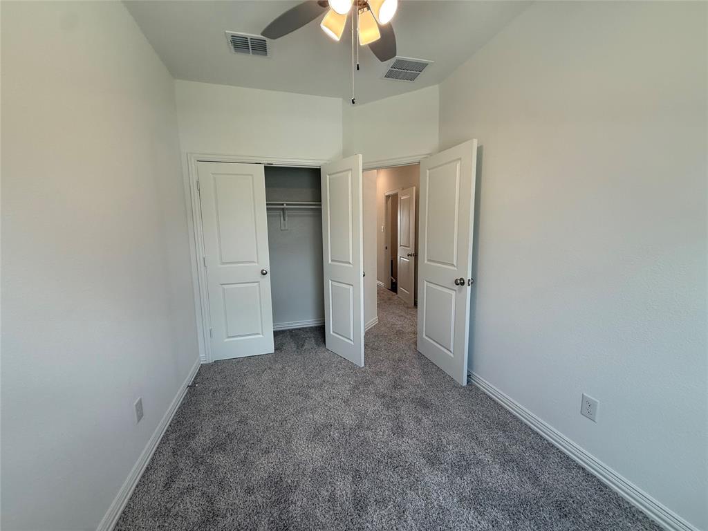 412 East 7th Street, Unit 2 Bonham, TX 75418 - Photo 17 of 20 an empty room with a ceiling fan and a window