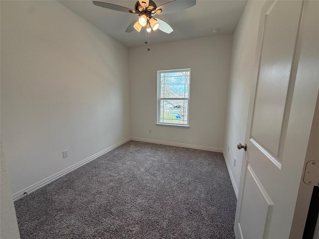 412 East 7th Street, Unit 2 Bonham, TX 75418 - Photo 18 of 20 an empty room with windows and fan