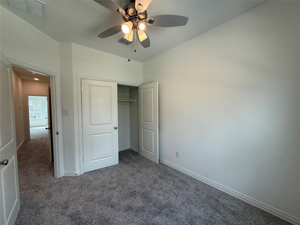 412 East 7th Street, Unit 2 Bonham, TX 75418 - Photo 19 of 20 an empty room with a empty space and a ceiling fan