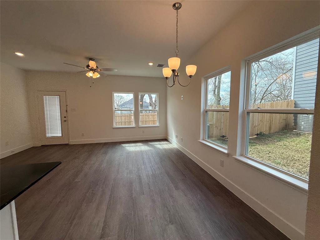 412 East 7th Street, Unit 2 Bonham, TX 75418 - Photo 6 of 20 a view of a room with wooden floors and chandelier