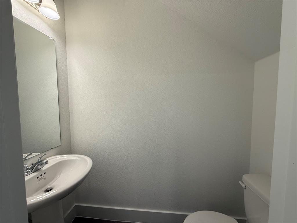 412 East 7th Street, Unit 2 Bonham, TX 75418 - Photo 9 of 20 a bathroom with a sink and a toilet