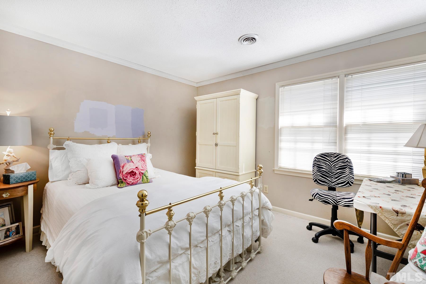 304 Sandhurst Road Raleigh, NC 27615 - Photo 17 of 28 a bedroom with a bed and a large window