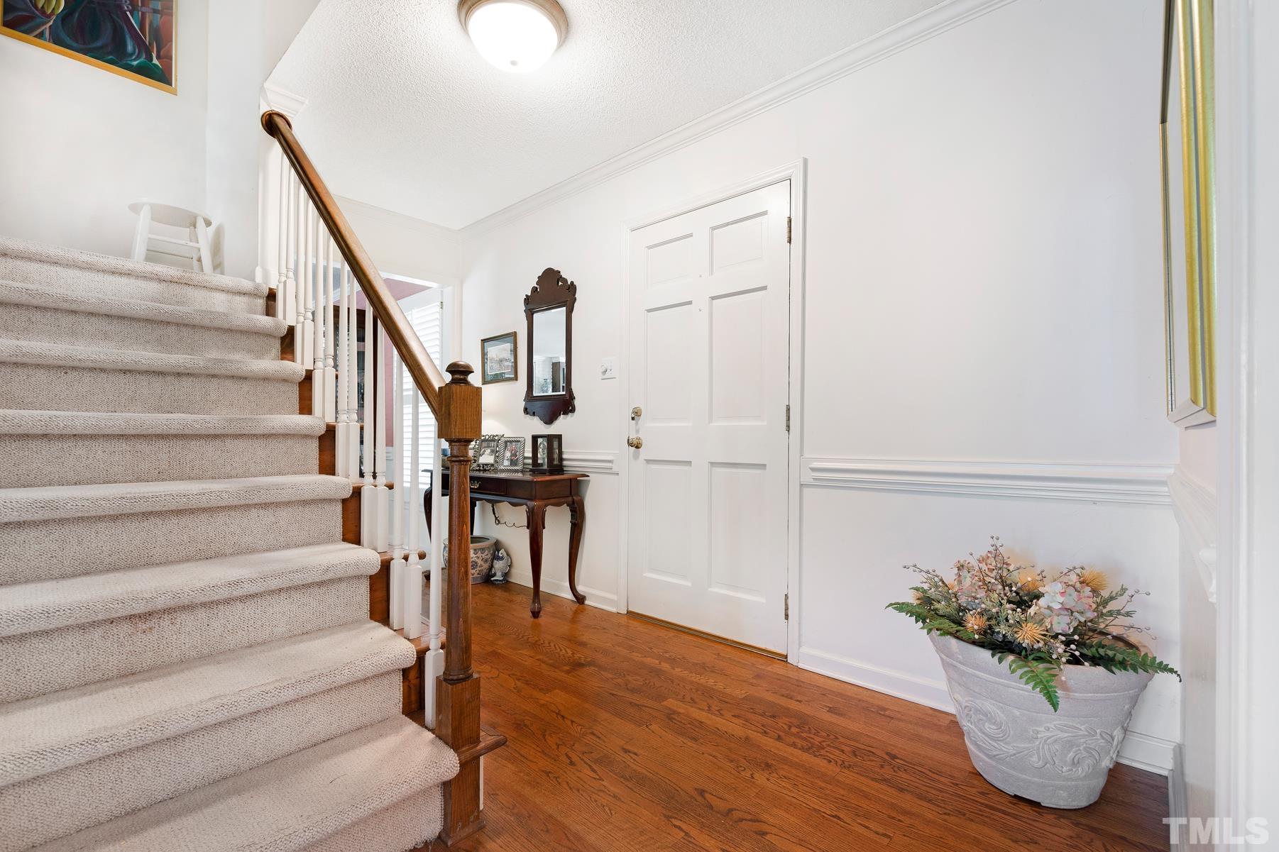304 Sandhurst Road Raleigh, NC 27615 - Photo 3 of 28 a view of entryway and hall with wooden floor