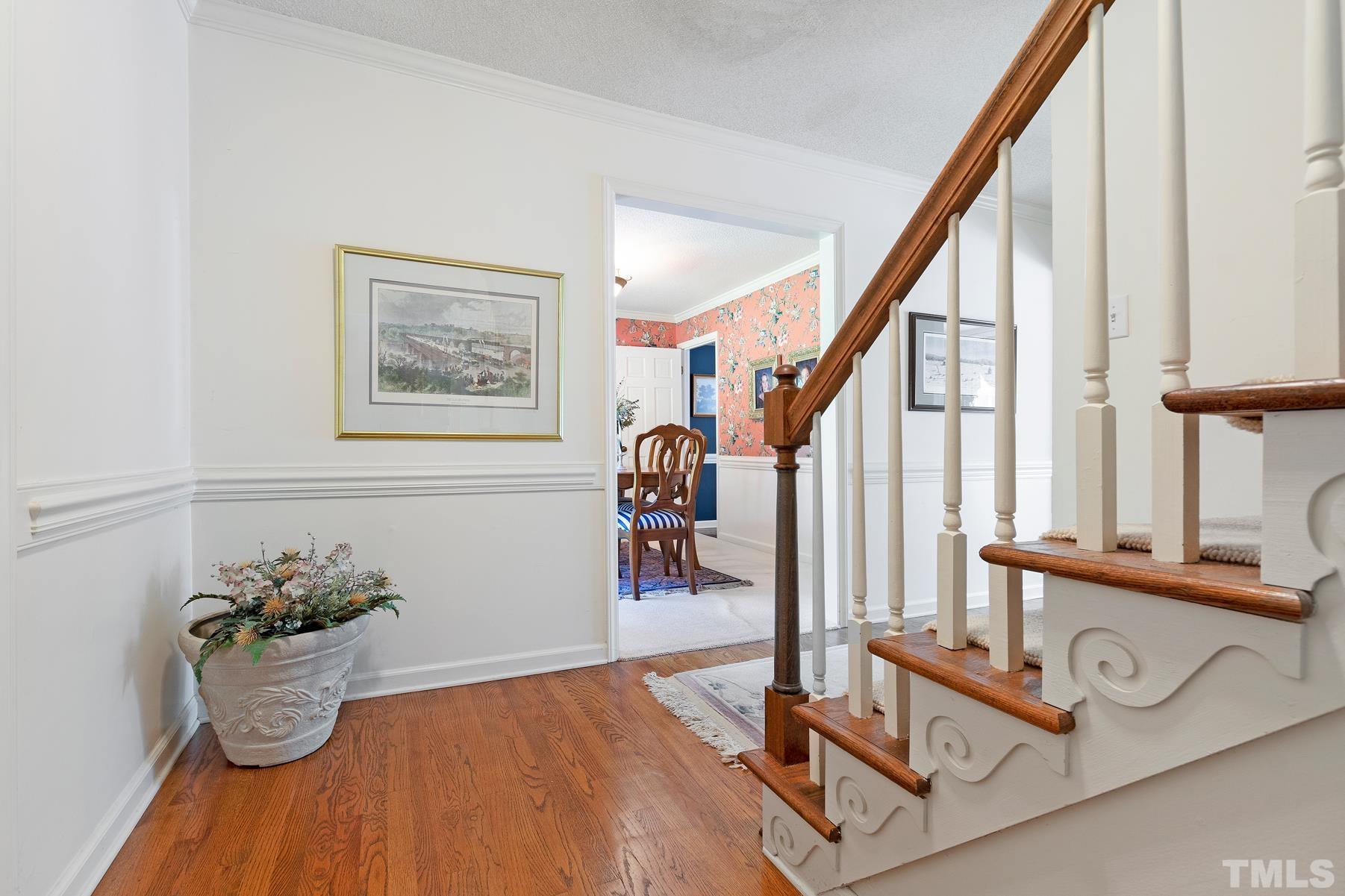 304 Sandhurst Road Raleigh, NC 27615 - Photo 4 of 28 a view of a dining room with wooden floor and stairs
