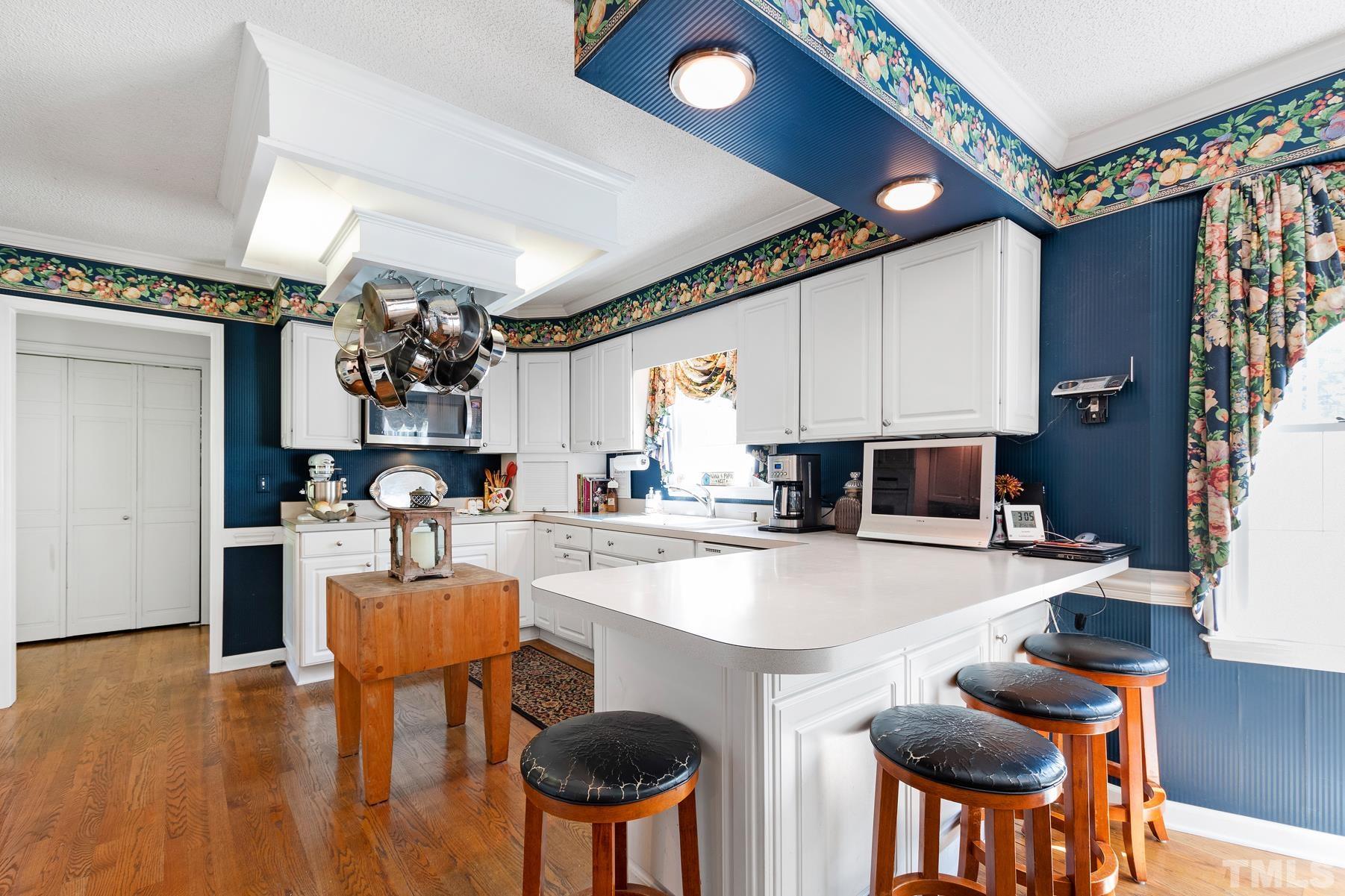 304 Sandhurst Road Raleigh, NC 27615 - Photo 8 of 28 a kitchen with a dining table and chairs