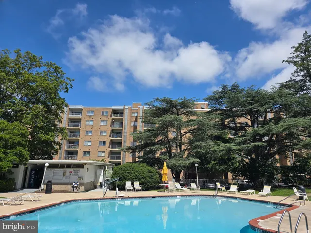 a view of swimming pool with outdoor seating and city view