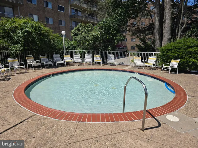a view of swimming pool with seating space