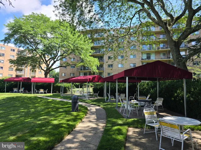 a view of a chairs and table under an umbrella