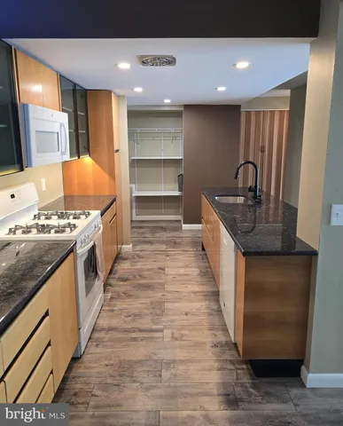 a kitchen with stainless steel appliances granite countertop a stove and a kitchen island