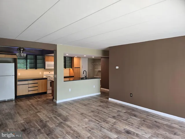 a view of a livingroom with furniture and a bathroom