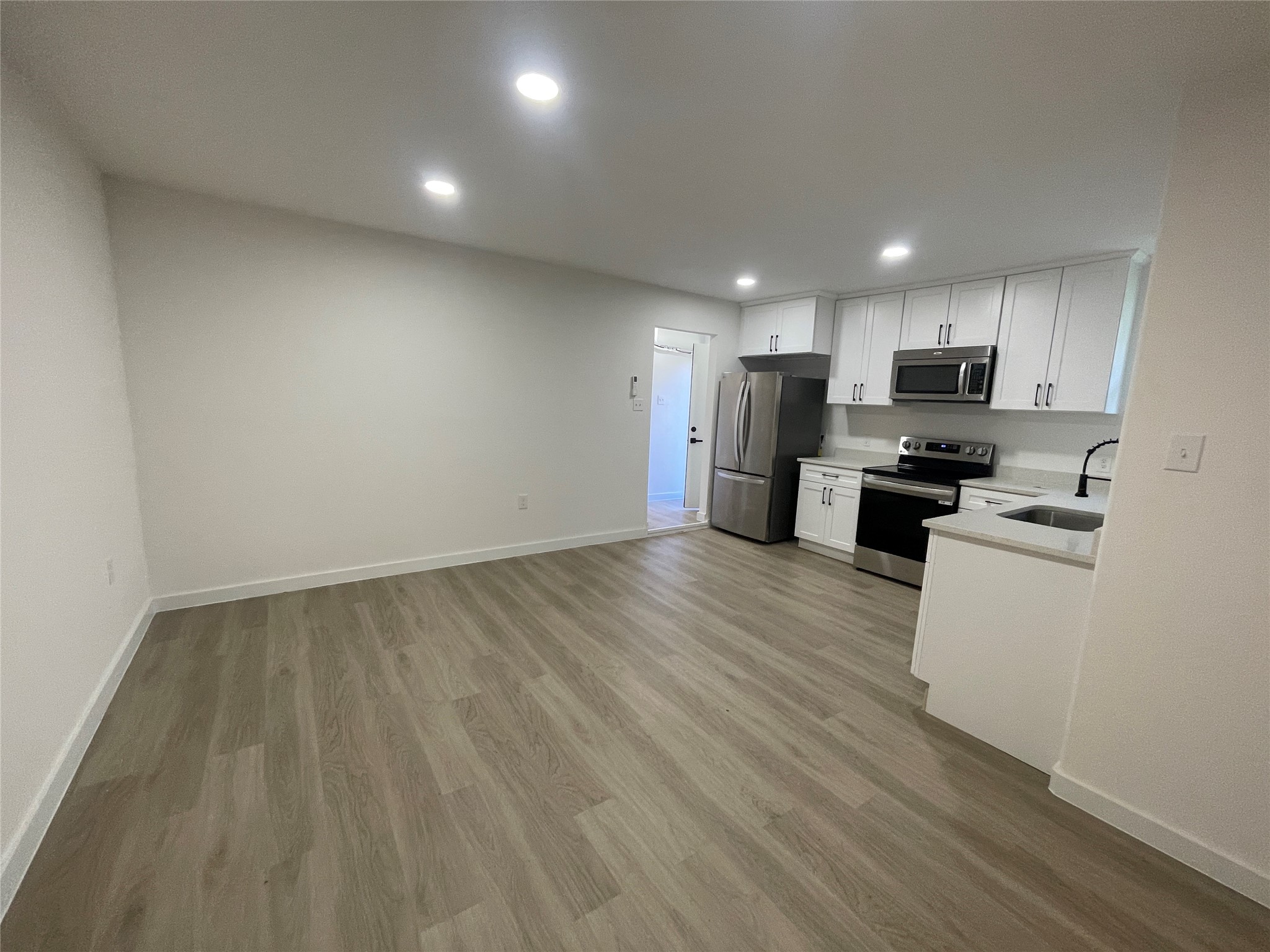 5602 Circlegate Drive, Unit B Spring, TX 77373 - Photo 4 of 8 a view of kitchen with wooden floor and electronic appliances