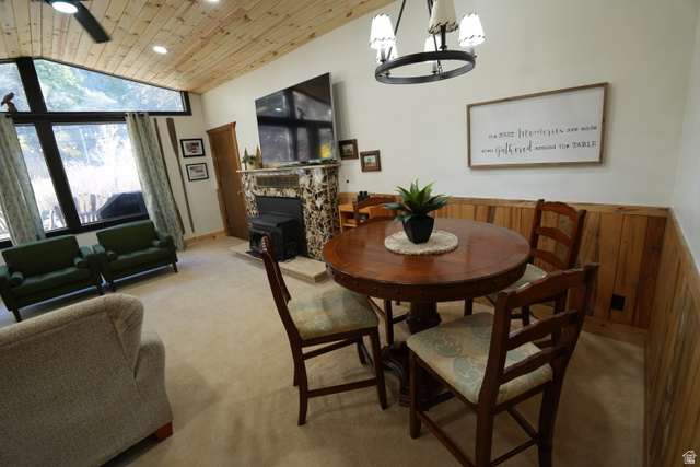 3711 North Canyon Road Provo, UT 84604 - Photo 24 of 42 Dining room with lofted ceiling, wooden ceiling, carpet, a chandelier, and a wood stove