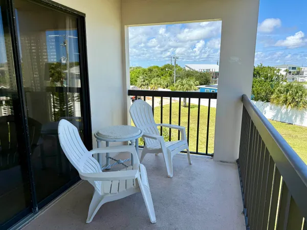 a view of a balcony with chairs