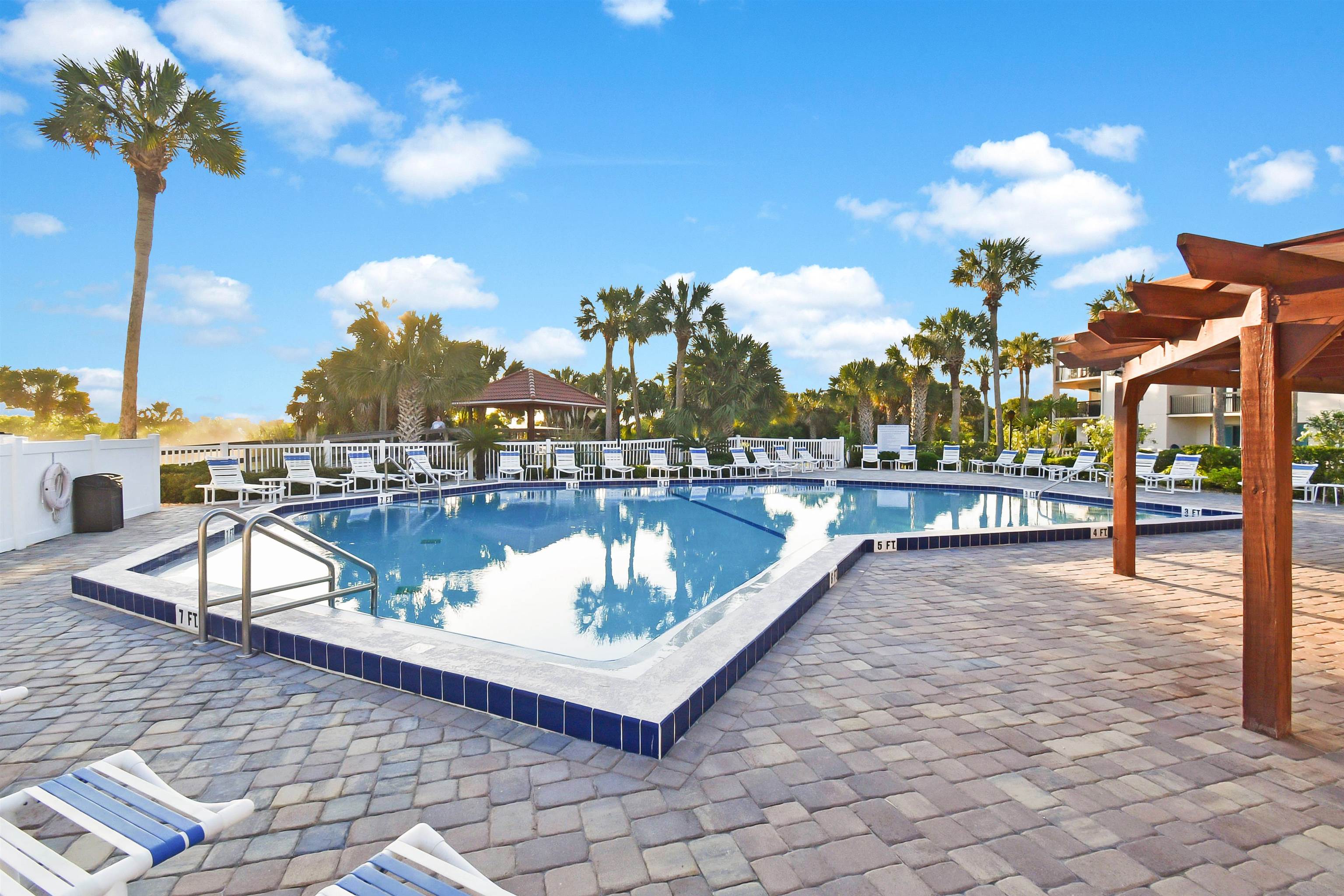 4250 A1A South, Unit M 31 St. Augustine, FL 32080 - Photo 15 of 21 a view of a swimming pool with a lounge chairs