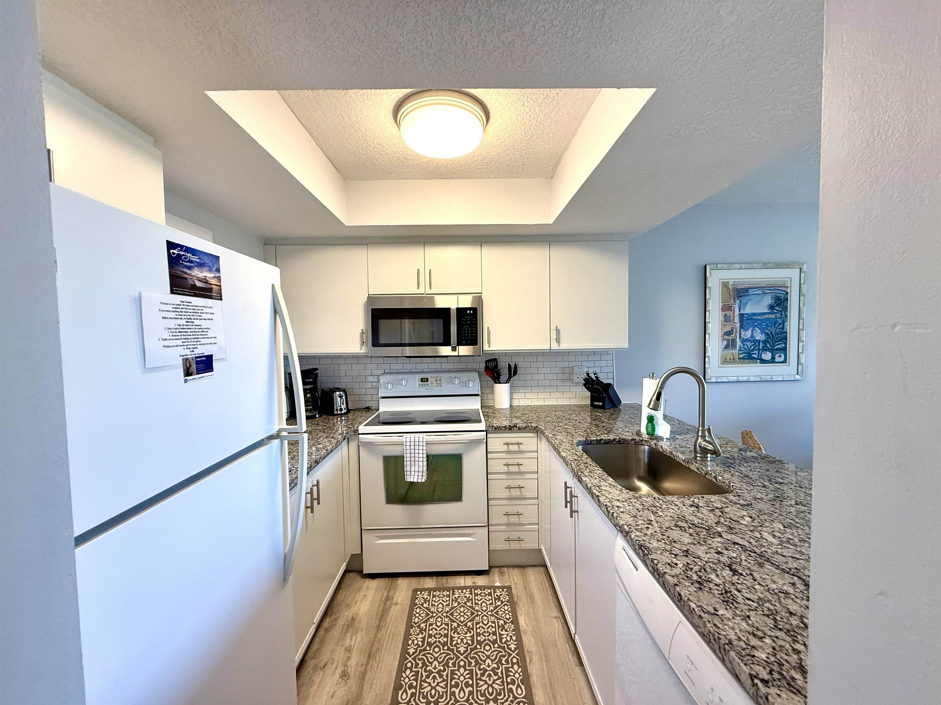4250 A1A South, Unit M 31 St. Augustine, FL 32080 - Photo 2 of 21 a kitchen with stainless steel appliances granite countertop a refrigerator sink and stove