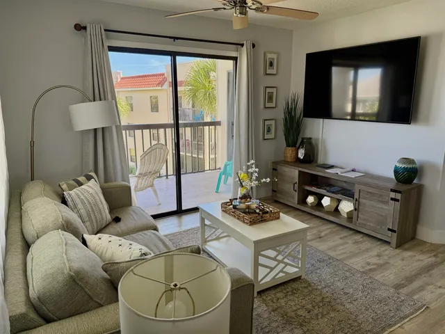a living room with furniture and a floor to ceiling window
