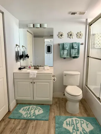 a bathroom with a sink toilet and mirror