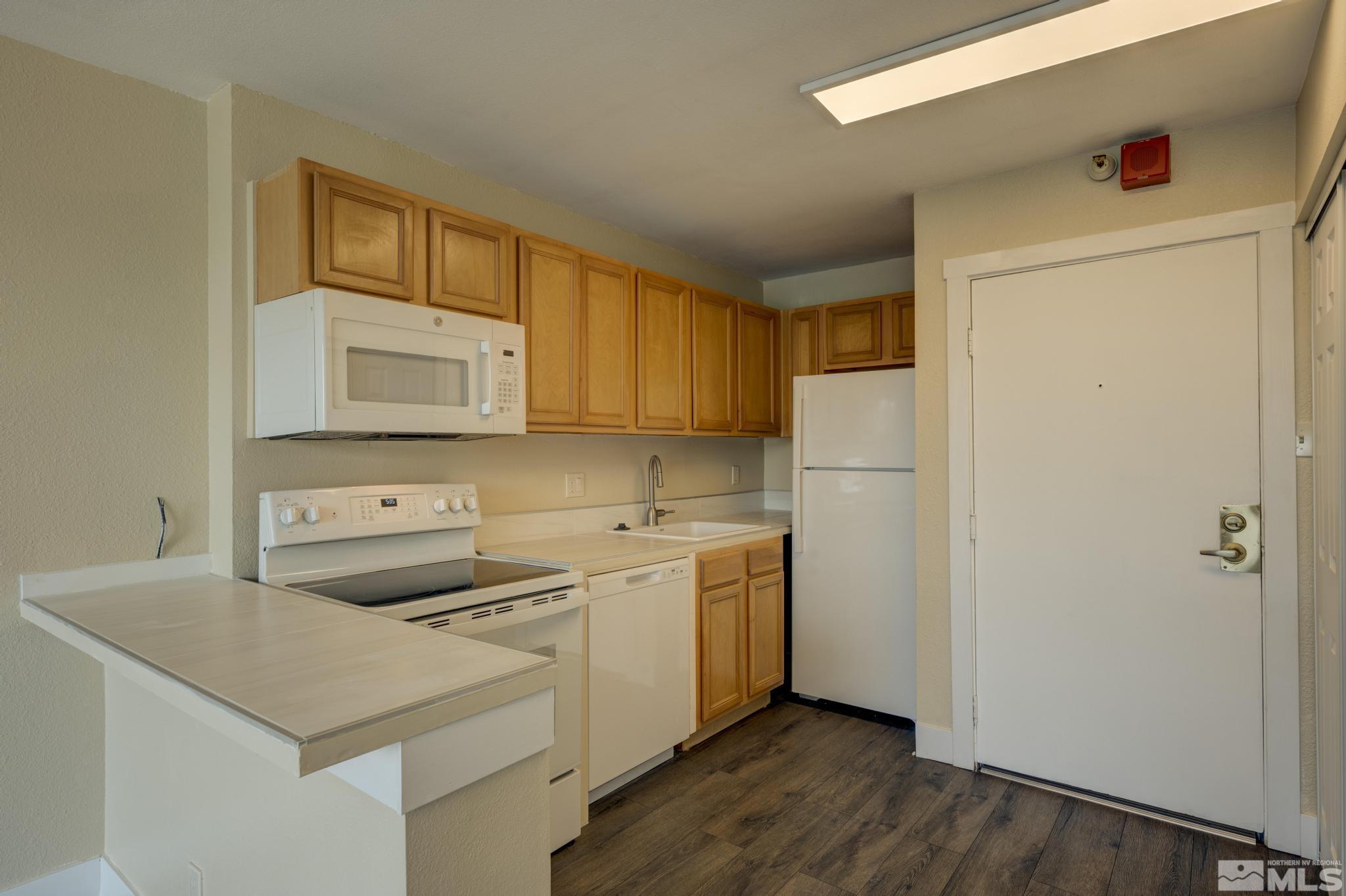 a kitchen with a sink a stove a refrigerator and cabinets