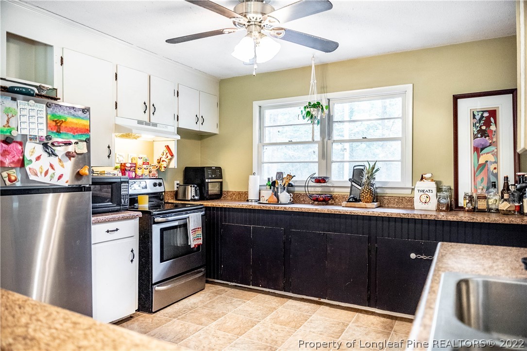 4064 Vass-Carthage Road Carthage, NC 28327 - Photo 8 of 50 a kitchen with stainless steel appliances granite countertop a sink and cabinets