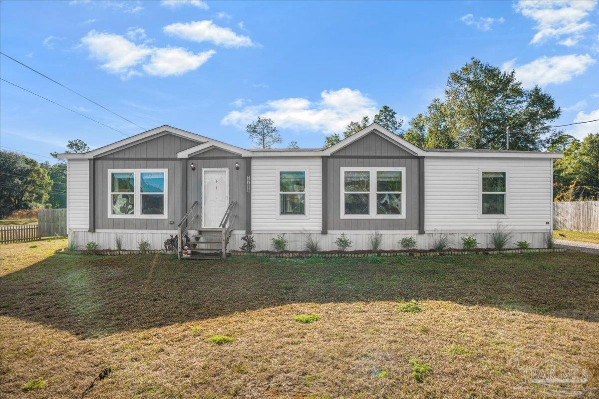 a front view of a house with a garden