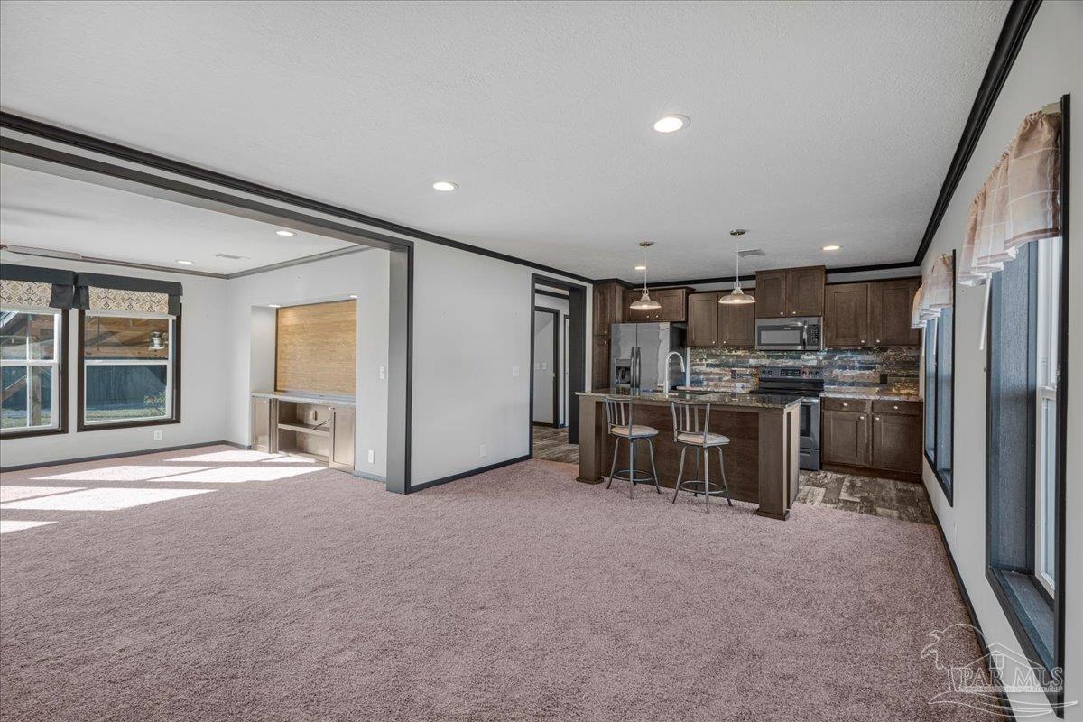 7789 Trinity Baptist Church Road Milton, FL 32570 - Photo 12 of 39 a view of a kitchen with refrigerator and microwave