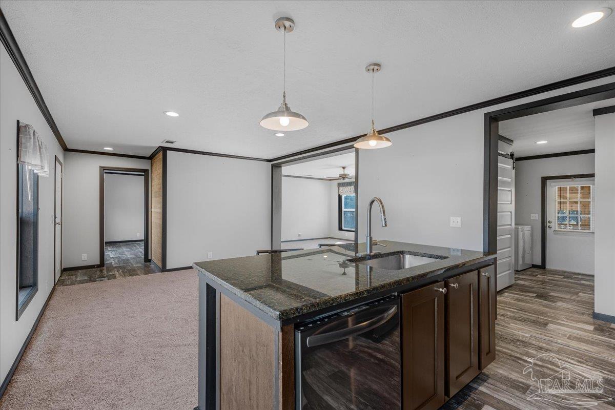 7789 Trinity Baptist Church Road Milton, FL 32570 - Photo 16 of 39 a kitchen with stainless steel appliances granite countertop a sink and a refrigerator