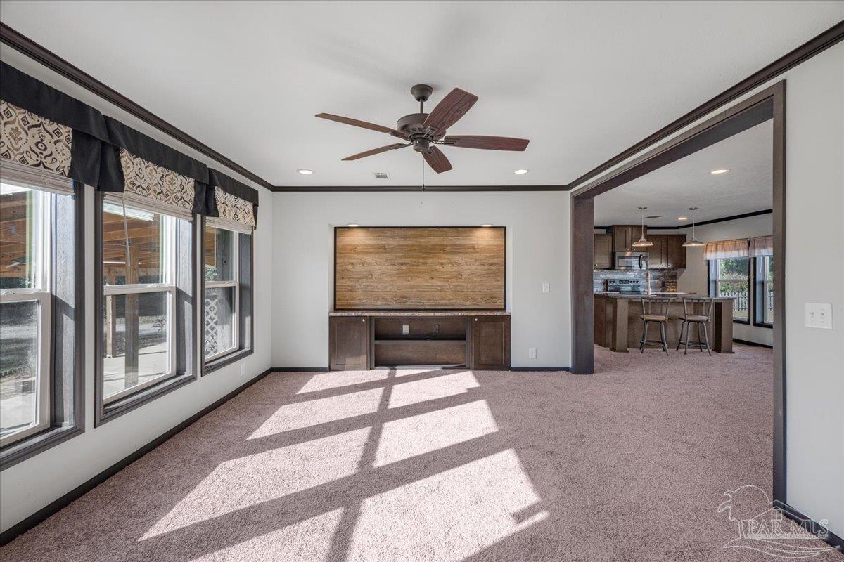 7789 Trinity Baptist Church Road Milton, FL 32570 - Photo 18 of 39 a living room with furniture a flat screen tv and a large window