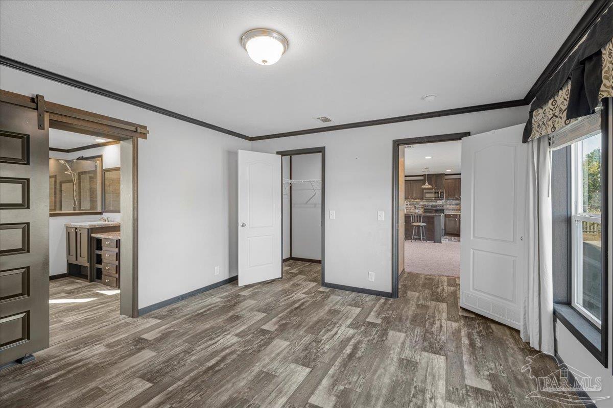 7789 Trinity Baptist Church Road Milton, FL 32570 - Photo 20 of 39 wooden floor in an empty room and a window