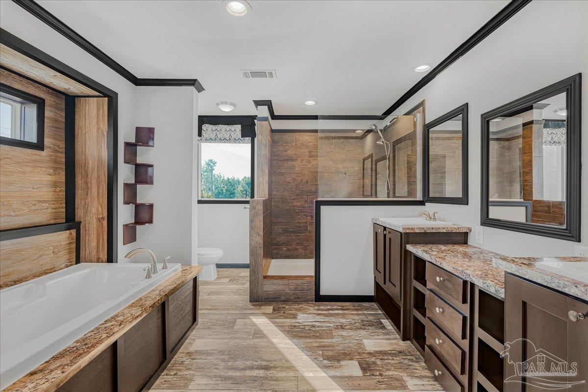 7789 Trinity Baptist Church Road Milton, FL 32570 - Photo 22 of 39 a spacious bathroom with a granite countertop tub sink and mirror