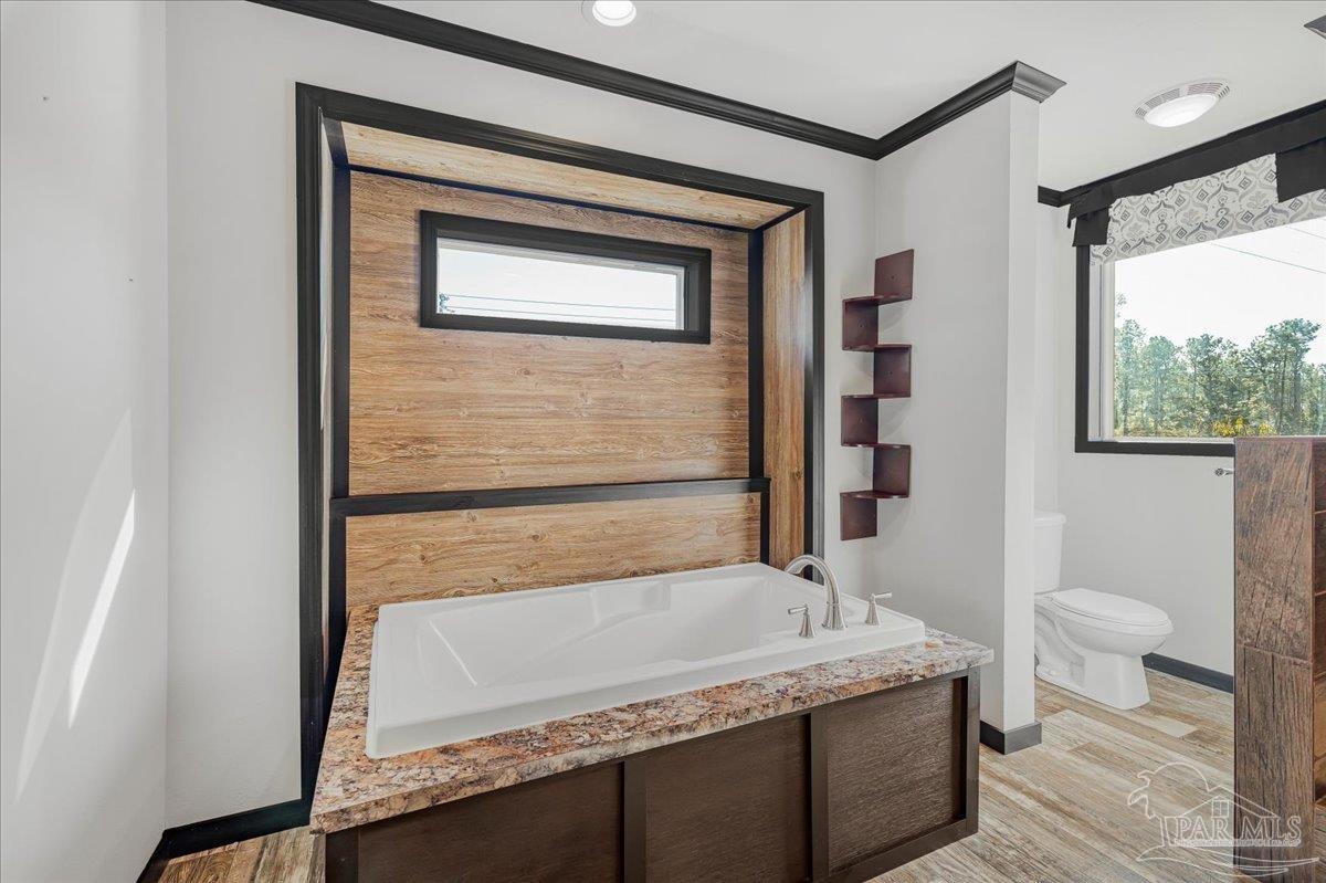 7789 Trinity Baptist Church Road Milton, FL 32570 - Photo 23 of 39 a bathroom with a granite countertop sink toilet and shower