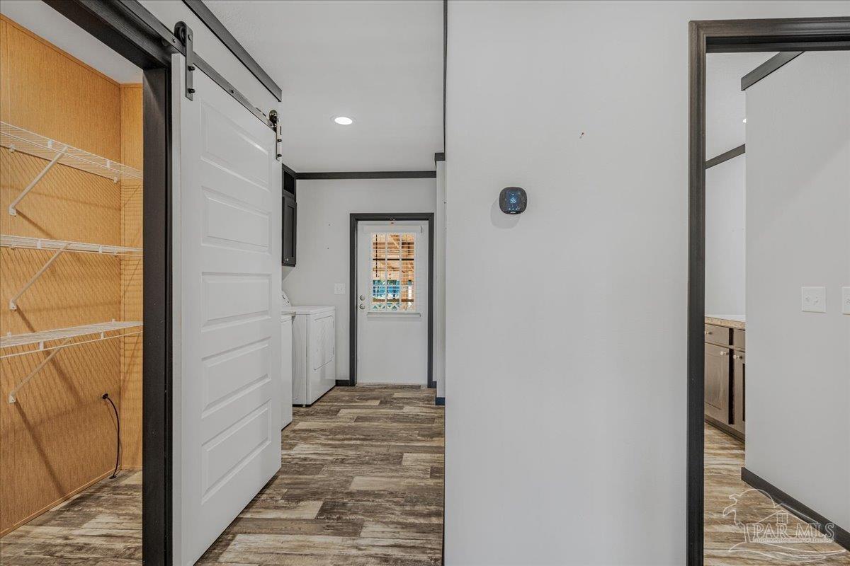 7789 Trinity Baptist Church Road Milton, FL 32570 - Photo 25 of 39 a view of a hallway with wooden floor and staircase