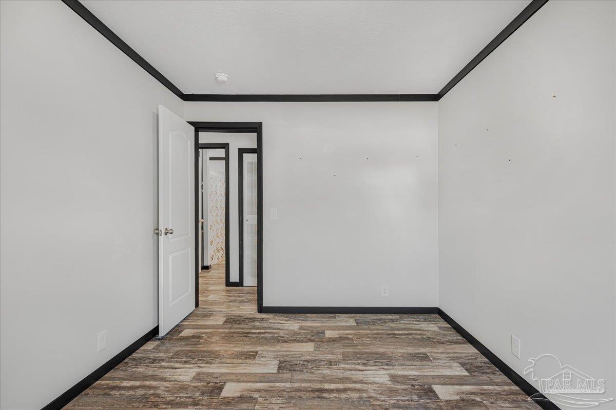 7789 Trinity Baptist Church Road Milton, FL 32570 - Photo 29 of 39 a view of an empty room with wooden floor