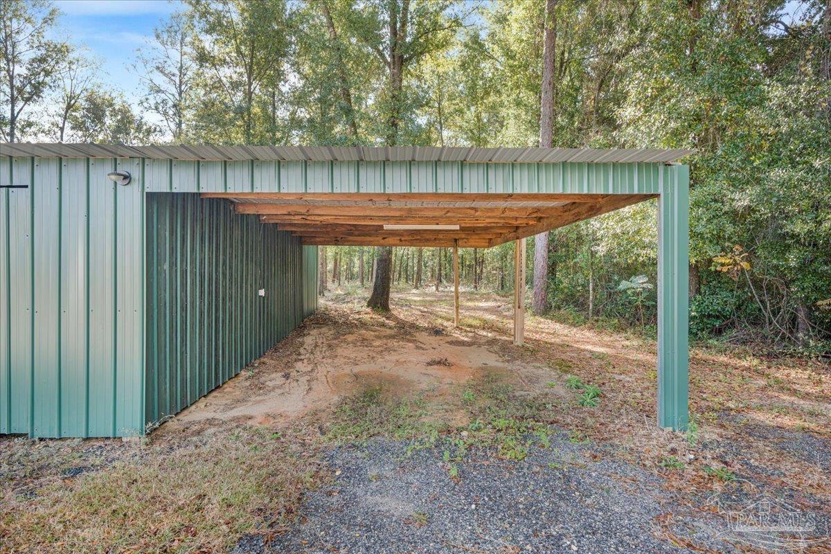 7789 Trinity Baptist Church Road Milton, FL 32570 - Photo 34 of 39 a backyard of a house with a fountain and outdoor seating
