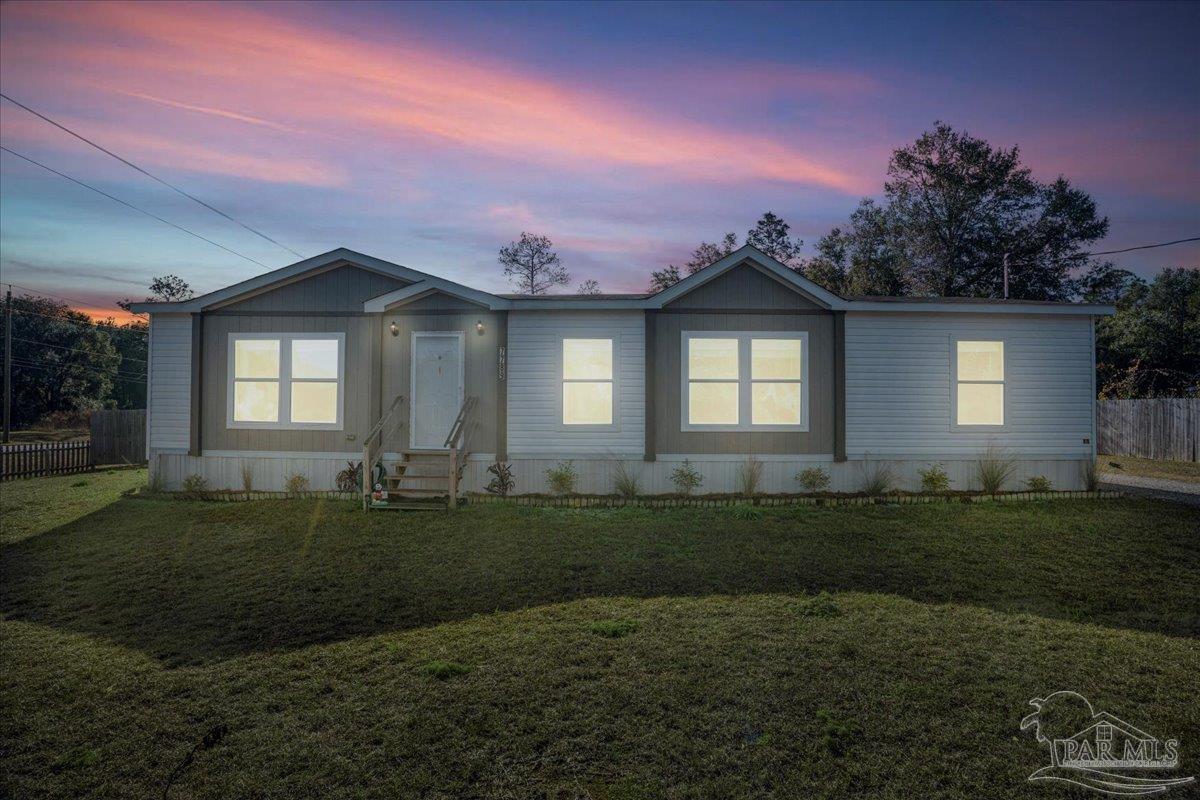 7789 Trinity Baptist Church Road Milton, FL 32570 - Photo 6 of 39 a front view of a house with a yard