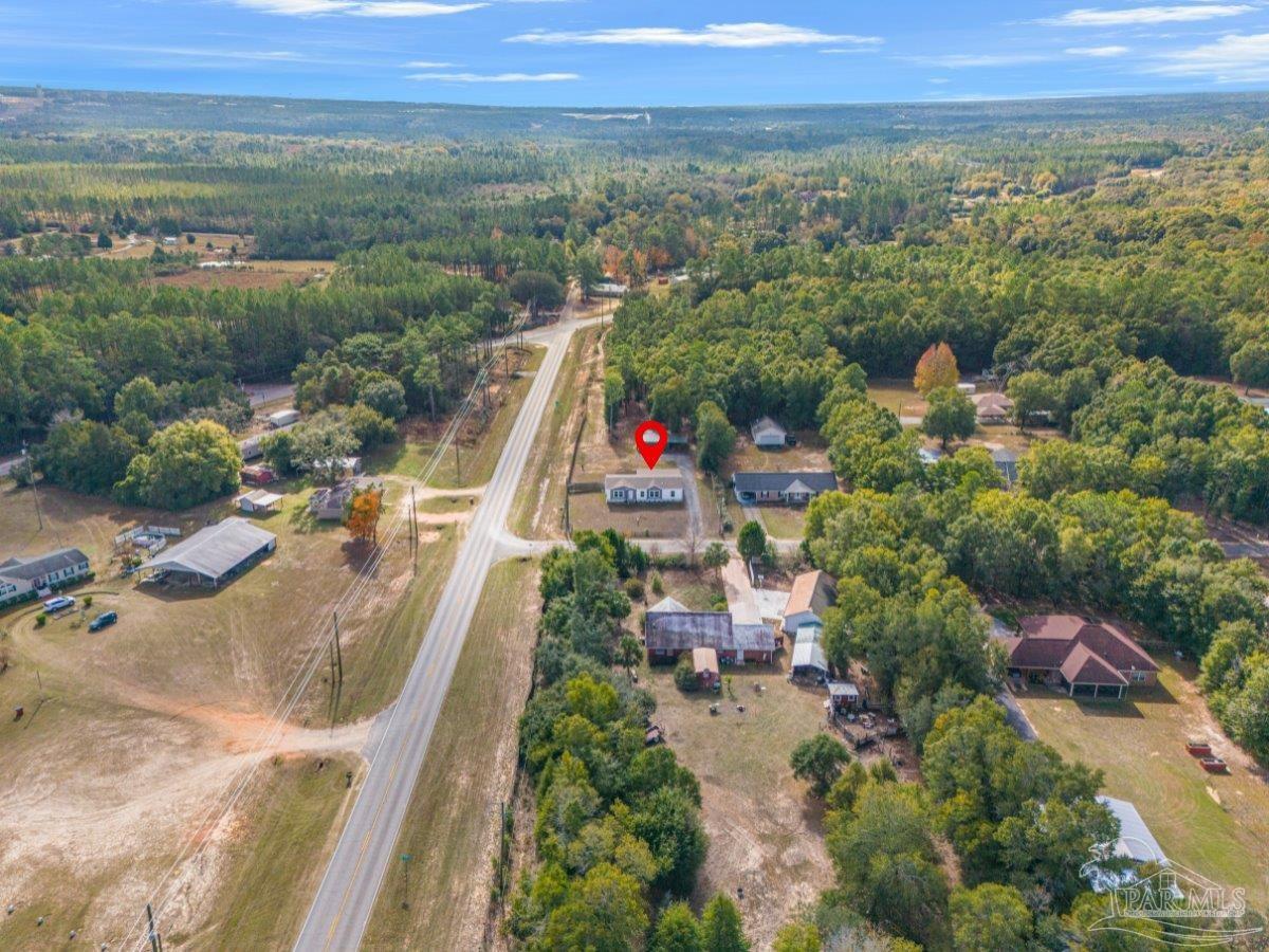7789 Trinity Baptist Church Road Milton, FL 32570 - Photo 8 of 39 an aerial view of a house with a yard and lake view