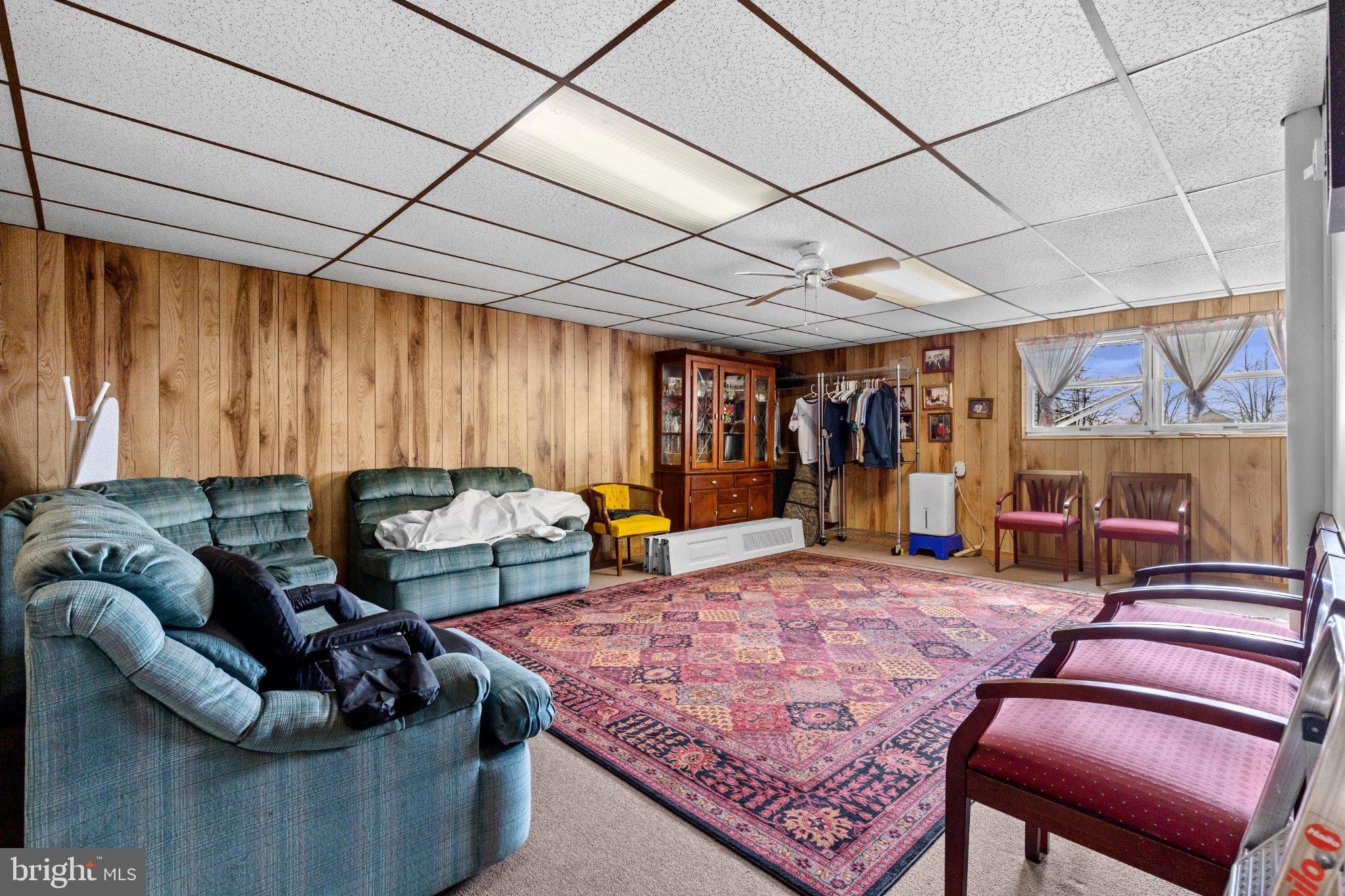 430 Fairview Road Manheim, PA 17545 - Photo 17 of 32 a living room with furniture a flat screen tv and a table