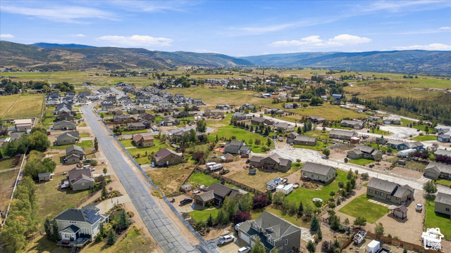437 Scenic Heights Road Kamas, UT 84036 - Photo 43 of 46 Residential neighborhood with paved roadways and varied home styles, surrounded by expansive green fields and distant mountains