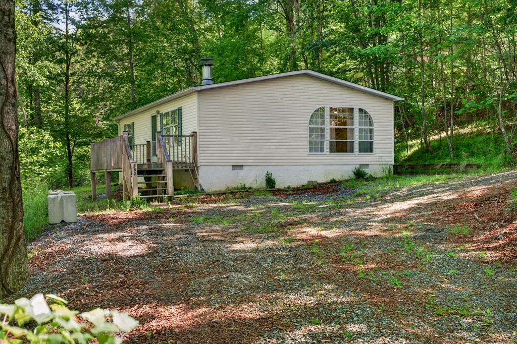 282 West Cherry Road Hayesville, NC 28904 - Photo 2 of 45 a view of a backyard with plants and large trees