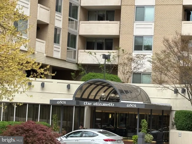 a front view of a building with a garden