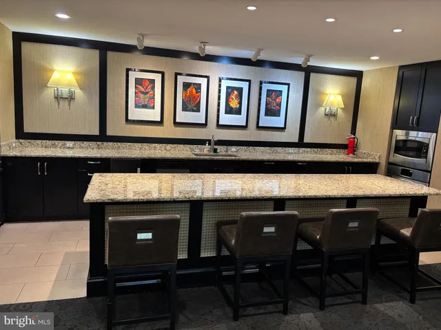 a view of a kitchen with a sink a table and chairs in it