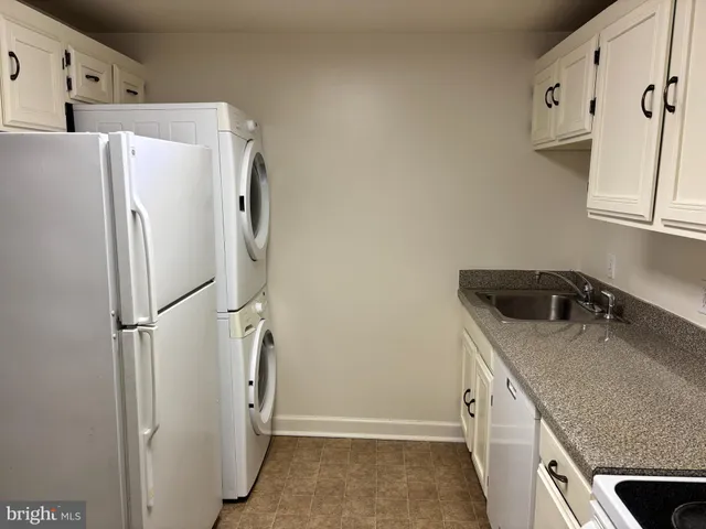 a white refrigerator freezer sitting inside of a kitchen