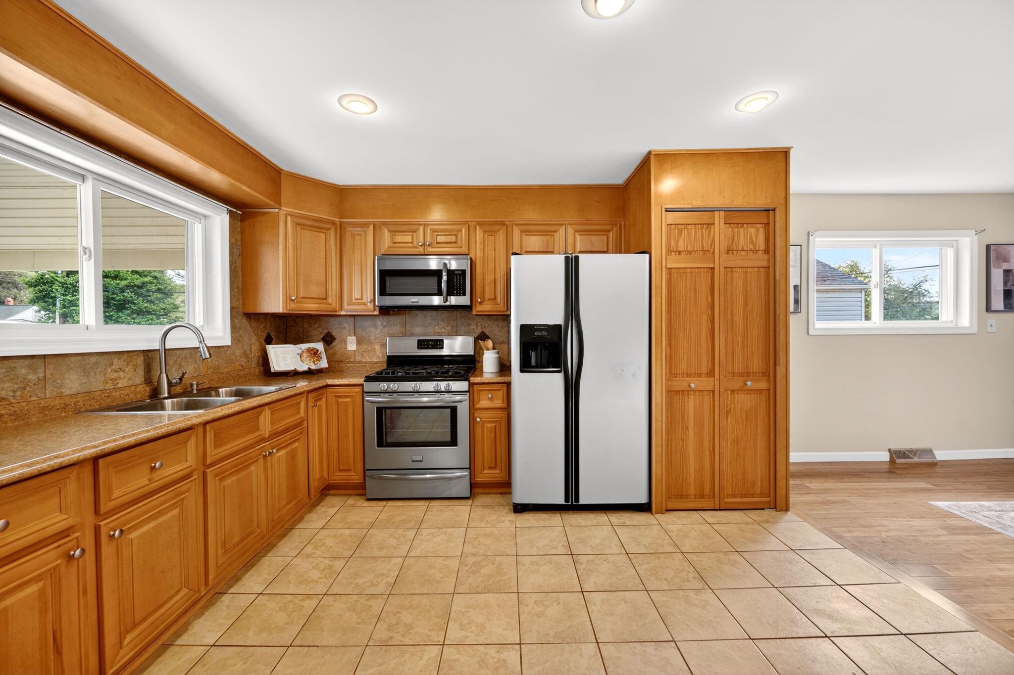 206 South Woodwell Road Baltimore, MD 21222 - Photo 11 of 46 a kitchen with stainless steel appliances granite countertop a refrigerator and a stove top oven