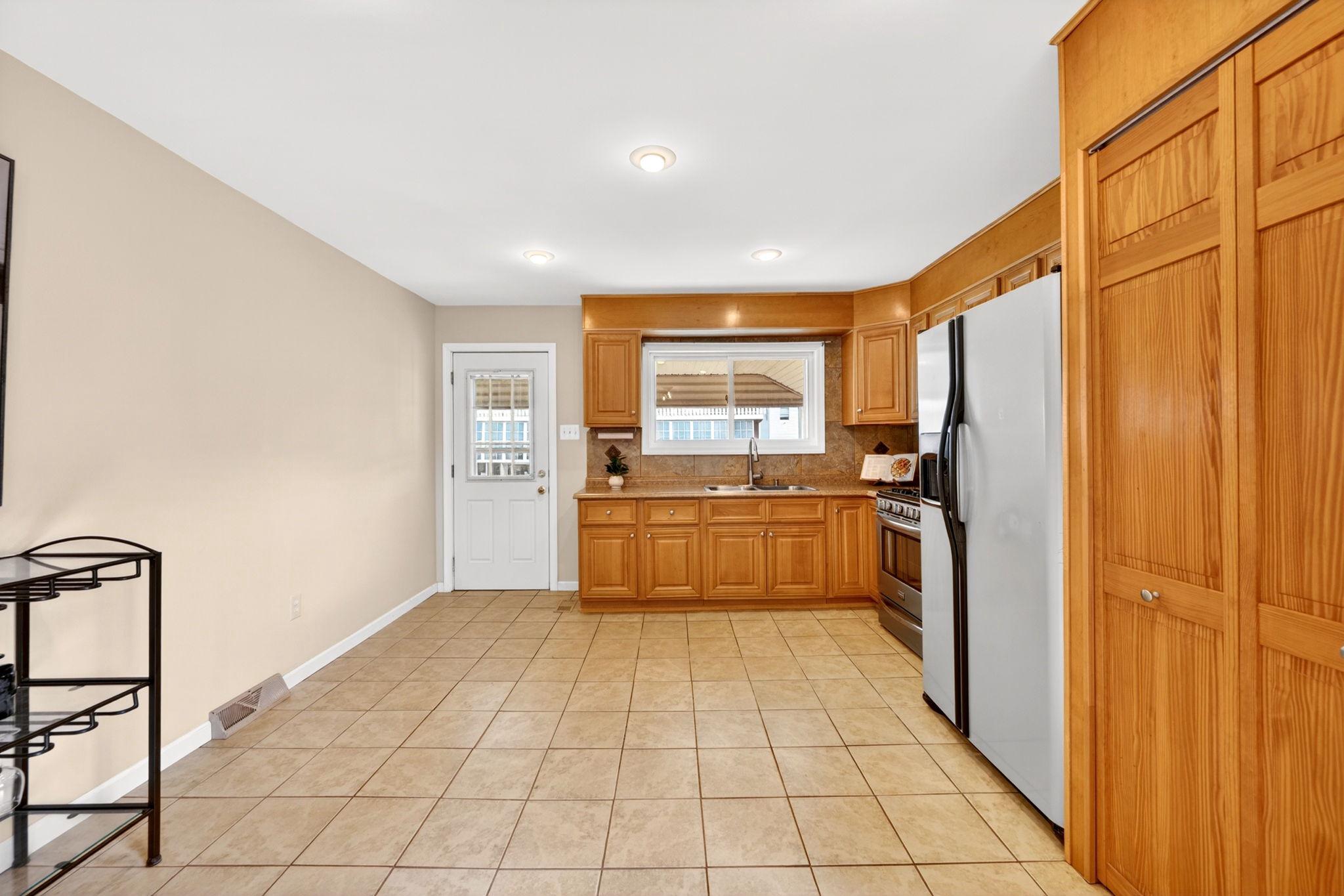 206 South Woodwell Road Baltimore, MD 21222 - Photo 13 of 46 a kitchen with stainless steel appliances a refrigerator and a stove top oven