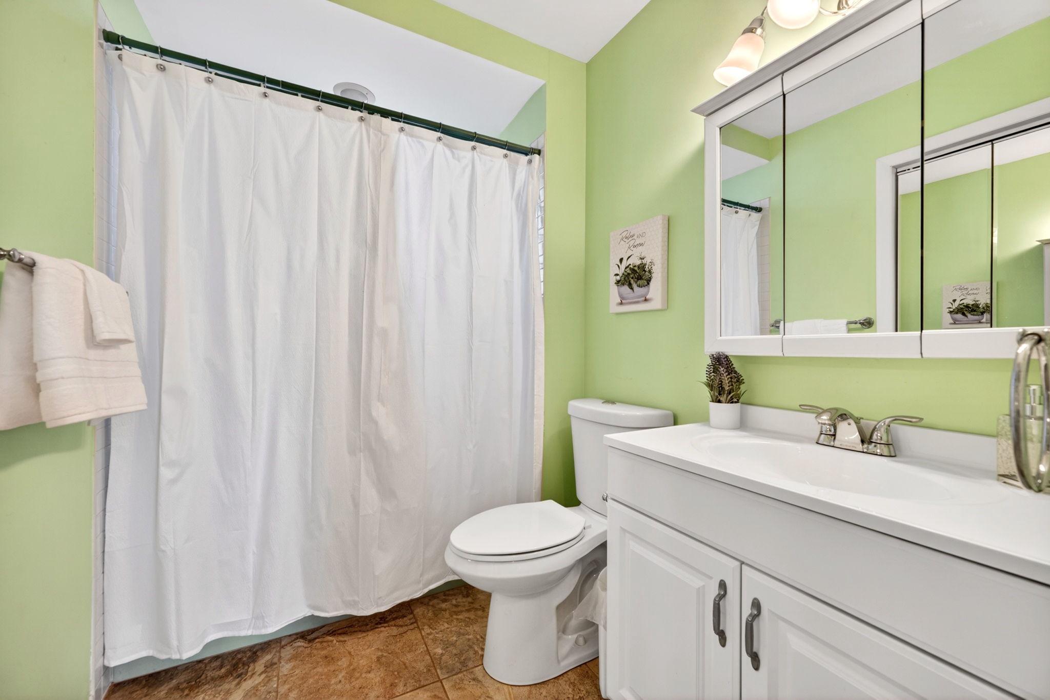 206 South Woodwell Road Baltimore, MD 21222 - Photo 16 of 46 a bathroom with a sink a toilet and a mirror