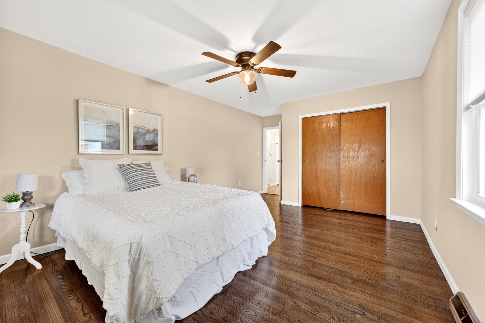 206 South Woodwell Road Baltimore, MD 21222 - Photo 18 of 46 a bedroom with a large bed and a chandelier